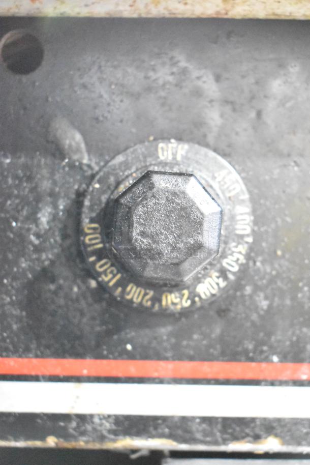 Close-up of a Wolf Regency griddle thermostatic control knob showing temperature markings and off position, used condition.