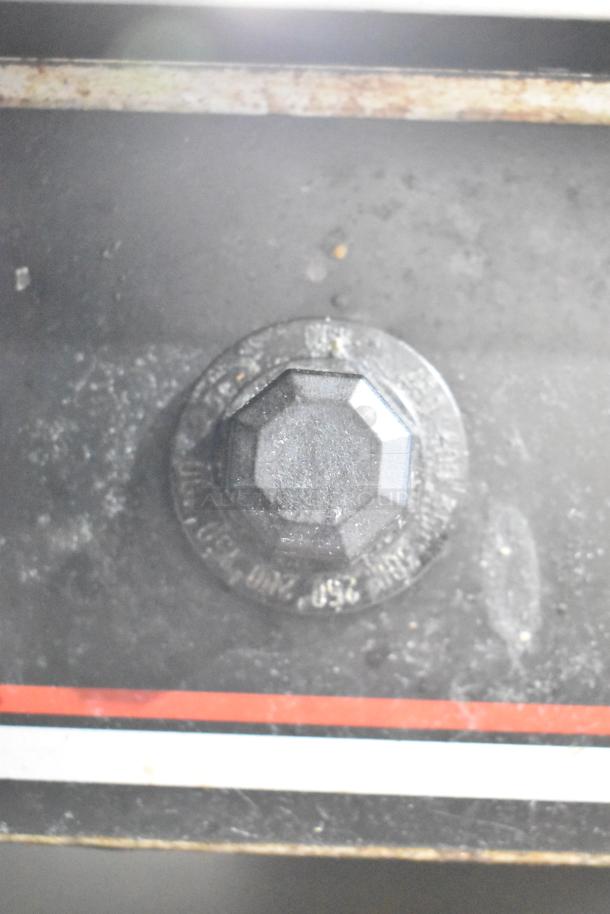 Wolf Regency commercial countertop flat top griddle with thermostatic controls, on equipment stand with commercial casters.