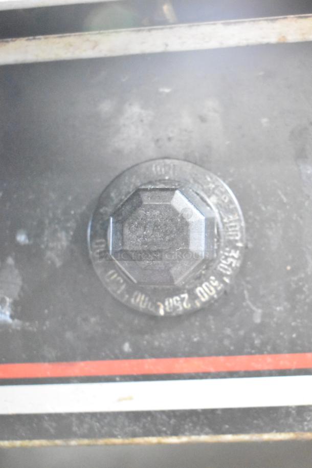 Wolf Regency commercial countertop flat-top griddle with thermostatic controls shown on equipment stand with commercial casters.