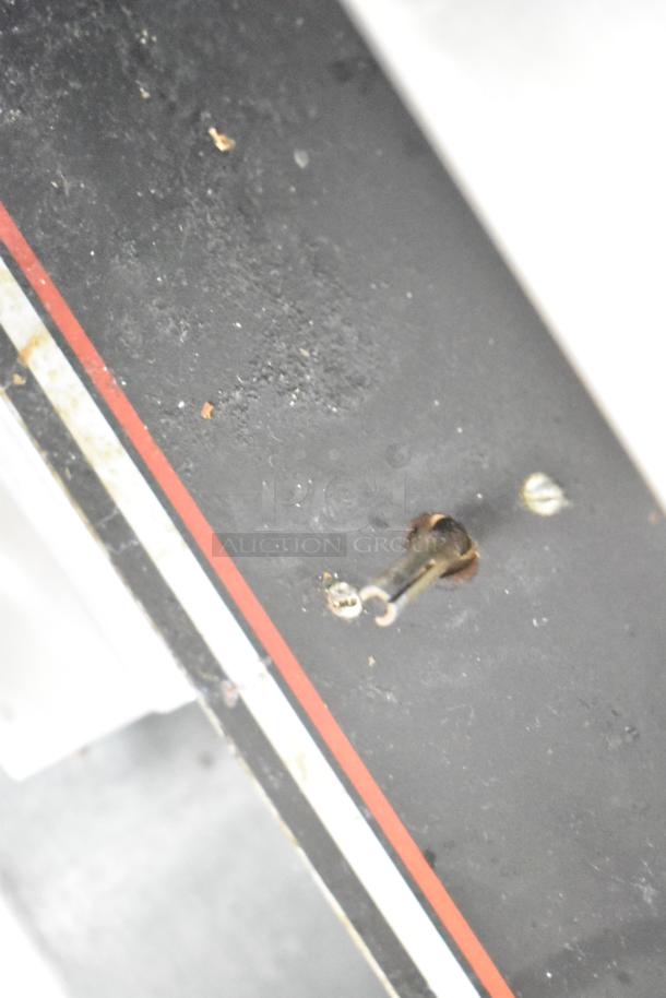 Close-up view of a Wolf Regency griddle surface and control panel, showing minor wear. Features thermostatic controls.