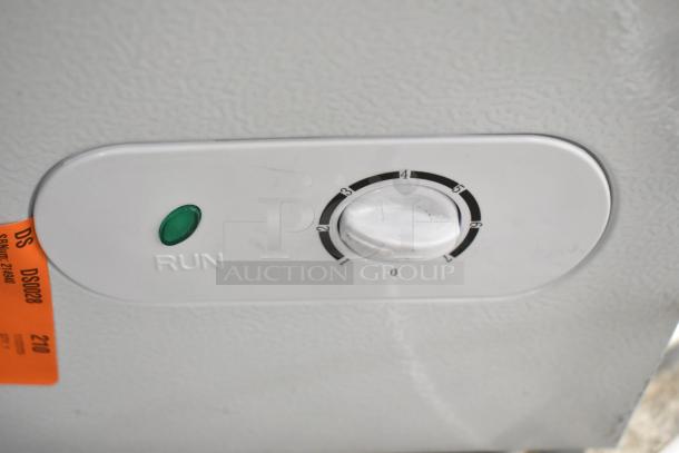 Vissani HMCF7W5 chest freezer control panel with temperature dial and green indicator light. Orange inspection tag visible.