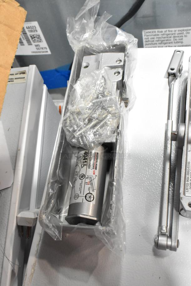 Three items, including Ingersoll-Rand 4041 door closer, Norton 1601 door closer, in packaging with installation screws.