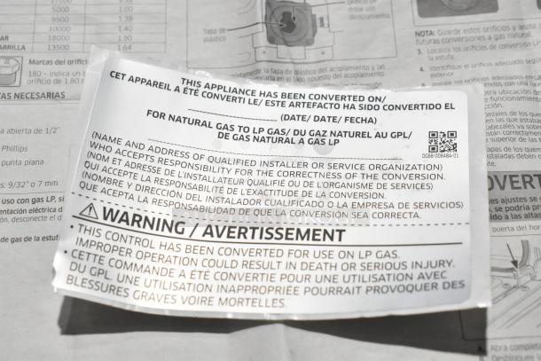 Brand new Samsung gas 4-burner range with two ovens, scratch and dent, missing grates, converted for LP gas use.