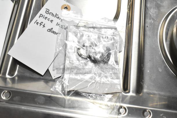 Brand new Samsung gas range, 4 burners, 2 ovens. Missing grates, scratch and dent condition. Tags note broken piece inside left door.