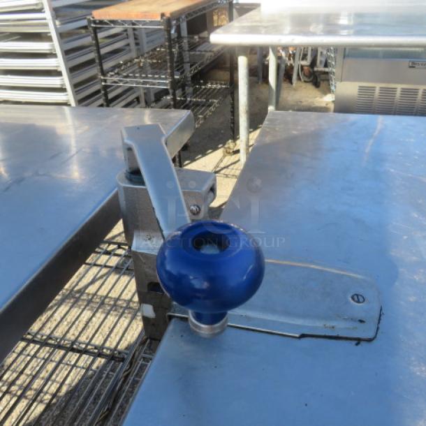 Stainless steel table with under shelf and mounted 10lb can opener, 36x36x34 inches, in good condition.