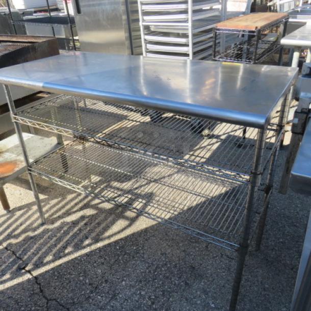 Stainless steel table, 48x24x37, with two Metro wire under shelves. Durable, suitable for kitchen or storage use.