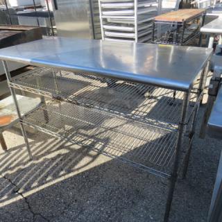 Stainless steel table, 48x24x37, with two Metro wire under shelves. Durable, suitable for kitchen or storage use.