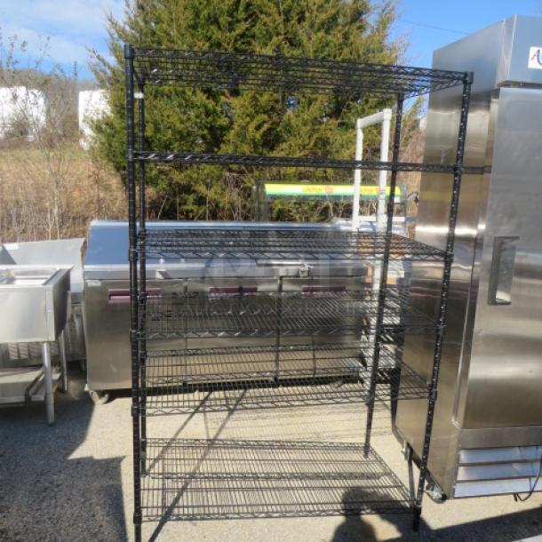 Black Metro shelf with six adjustable wire shelves, dimensions 48x24x75 inches, in used condition.