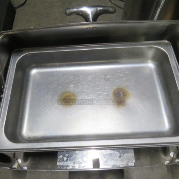 Heavy duty stainless steel full size roll top chafer with visible wear and discoloration on the interior surface.