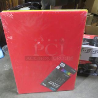 Red 24x18 cutting board, new and wrapped. Features label detailing 2XBID branding. Suitable for kitchen use.