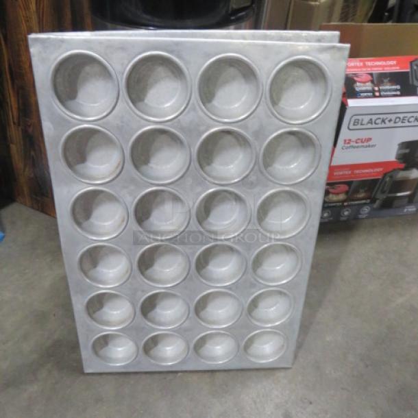 24-hole commercial muffin pan, metal construction, used condition. Suitable for large-scale baking needs.