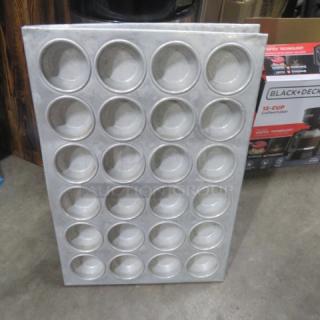 24-hole commercial muffin pan, metal construction, used condition. Suitable for large-scale baking needs.
