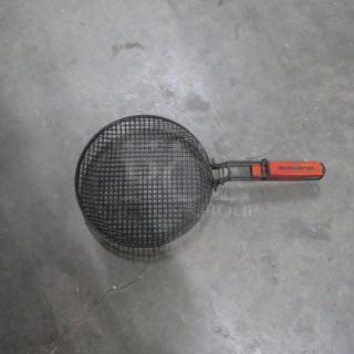 BBQ Masters 12-inch grilling basket with black mesh design and red handle. Used condition. Suitable for grilling vegetables.