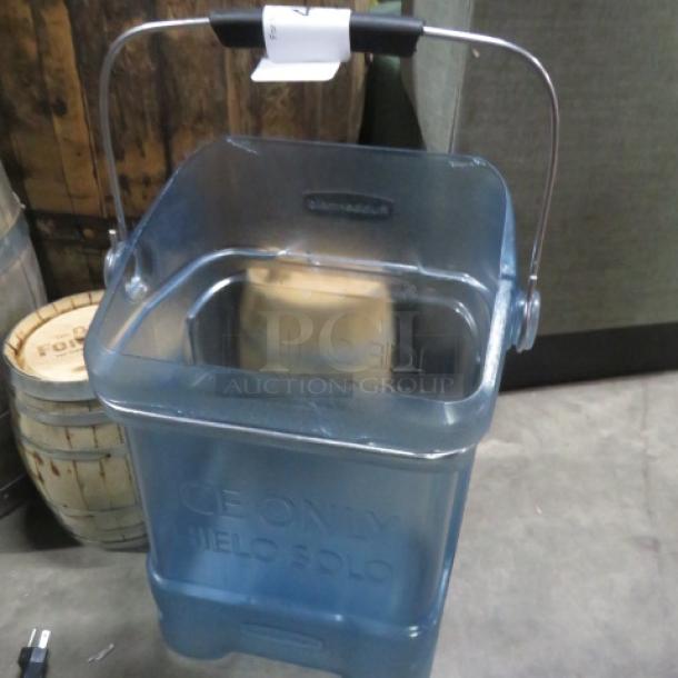 Transparent blue plastic ice bucket with handle, labeled "ICE ONLY," in good condition. Ideal for parties or events.