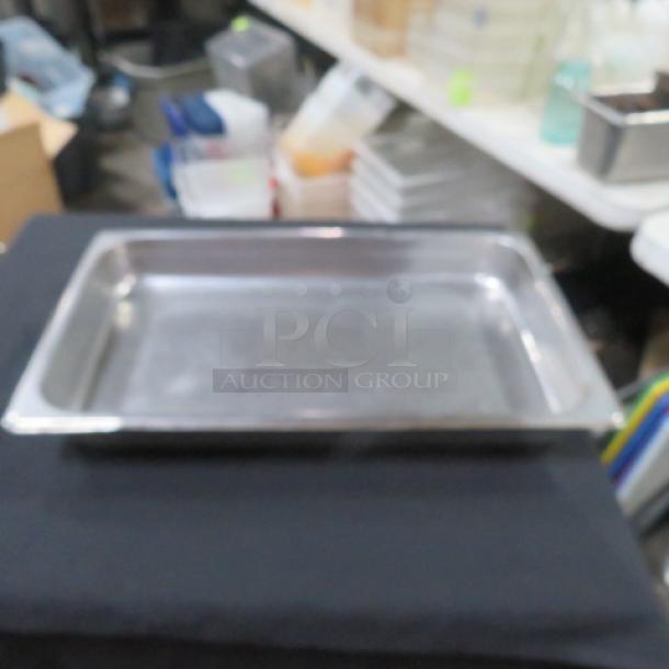 Stainless steel full-size 2.5-inch deep hotel pan, excellent condition, reflective surface, ideal for catering use.