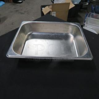 Half Size 2.5-inch deep hotel pan made of stainless steel, used condition, showing surface wear, suitable for food service.