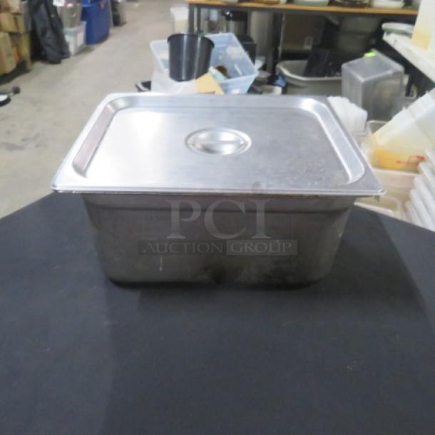 Half-size hotel pan with lid, 6-inch deep, stainless steel, used condition. Ideal for catering or food service.