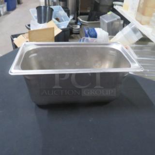 1/3 size, 6-inch deep stainless steel hotel pan, in used condition. No visible markings or labels.