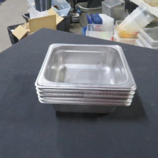 1/6 Size 2.5 Inch Deep Hotel Pan, stainless steel, stack of six, used, some signs of wear, suitable for commercial kitchens.