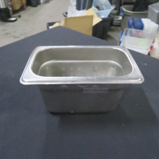 1/9 size, 4-inch deep stainless steel hotel pan. Used condition, suitable for commercial kitchen use, model 5XBID.