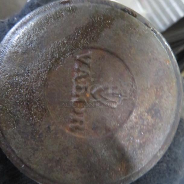 Valor Mini Cast Iron Pre Seasoned 16oz Pot with Lid. Visible wear on the bottom with "Valor" marking.