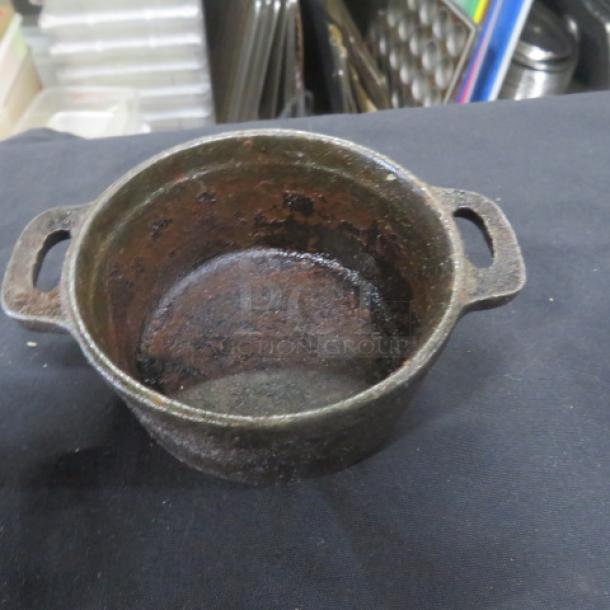 Valor Mini Cast Iron Pre Seasoned 16oz Pot, visible wear, dual handles, without lid, suitable for collectors.