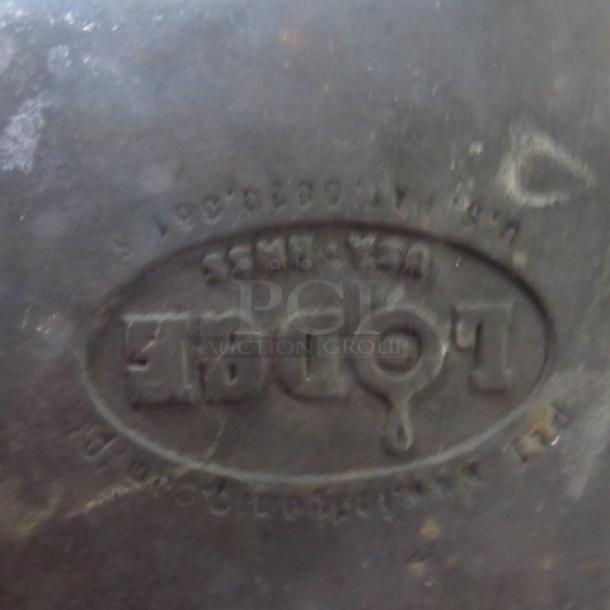 Lodge Cast Iron Pre-Seasoned Square Baking Dish with handles. Visible logo and markings indicate authenticity. Good condition.