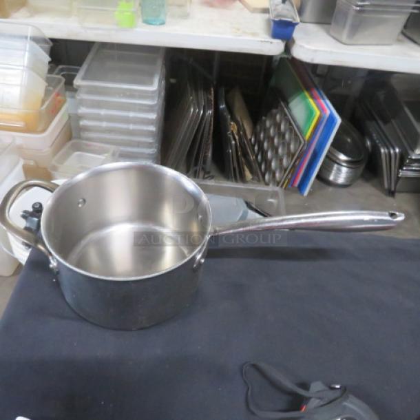 Williams Sonoma Thermo Clad Stainless Steel Saucepan, 7.5x5 inches, polished finish, excellent condition, sturdy handle.