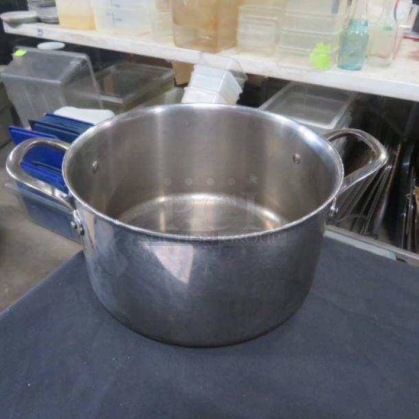 Williams Sonoma stainless steel Thermo-Clad stock pot, 11x6 inches, dual handles, shiny condition, durable cookware.