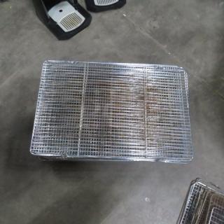 Assorted size cooling racks, metal mesh, stackable, showing slight wear, ideal for baking or cooking purposes.