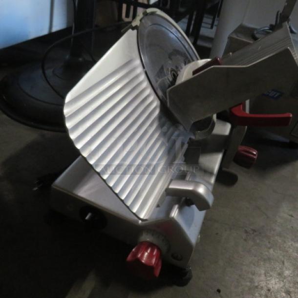 Berkel 12" deli slicer, model 827e, features adjustable slicing thickness, stainless steel, good condition, red control knobs.