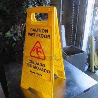 Yellow caution wet floor sign by Alpine, bilingual text, sturdy plastic, red slipping figure icon, indoor/outdoor use.