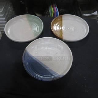 Three 10.5-inch assorted ceramic plates with green, brown, and blue glaze accents, in excellent condition.