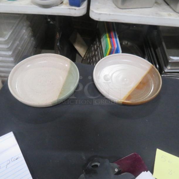 Two 8-inch assorted ceramic plates, each with dual-tone glaze, in excellent condition, marked "10XBID."