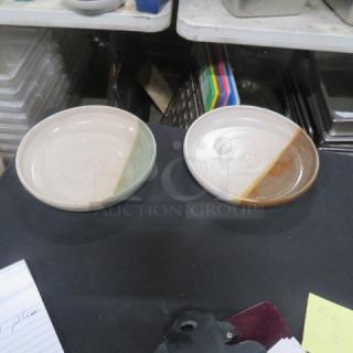 Two 8-inch assorted ceramic plates, each with dual-tone glaze, in excellent condition, marked "10XBID."