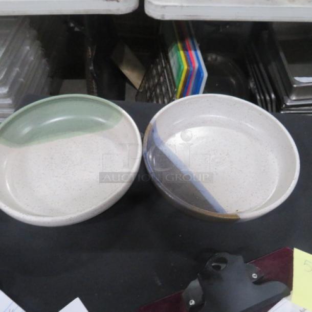 Two 9-inch assorted bowls, one with a green accent and the other with a blue stripe. Both are speckled and in good condition.