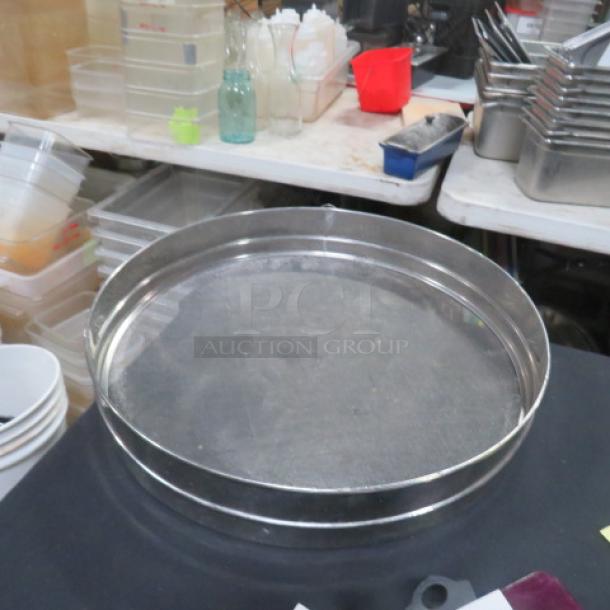 18-inch stainless steel sifter, mesh design, good condition. Ideal for baking, durable material. No visible markings.