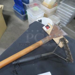 Assorted brush with wooden handle and metal bristles, showing signs of use. Attached label indicating 2XBID.