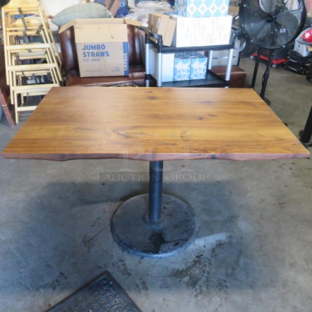 Solid wooden table with natural finish, 48x30x30 inches, on a round black pedestal base. Sturdy and elegant design.