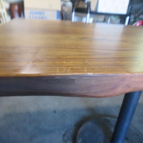 Solid wooden table with a pedestal base, 48x30x30 inches. Natural wood grain, excellent condition.