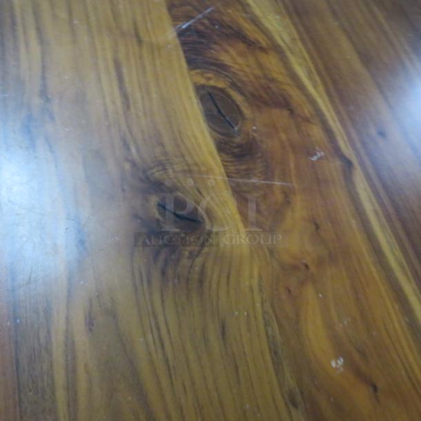 Solid wooden table with natural grain, pedestal base, 36x36x30 inches. Surface shows minor wear, enhancing rustic charm.