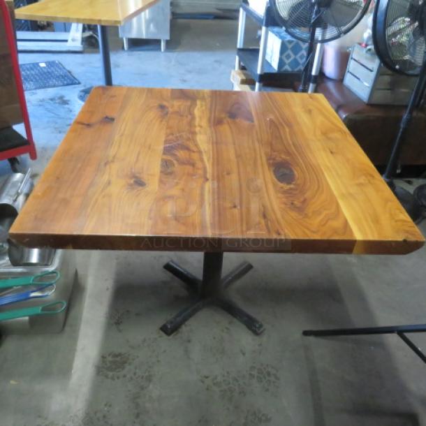 Solid wooden table with a natural finish on a pedestal base, 36x36x30 inches, excellent condition with unique wood grain.