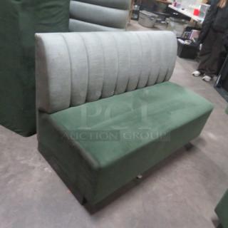 Single-sided green cushioned booth/bench, 75x26x34 inches, vertical panel backrest, good condition.