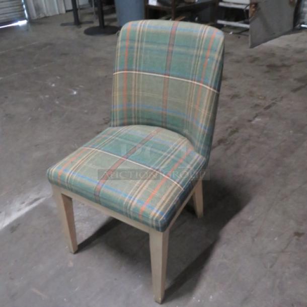 Pottery Barn green cushioned dining chair with plaid pattern, wooden legs. Excellent condition, sturdy design.