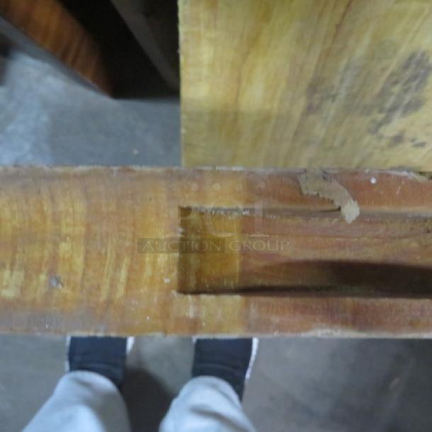 Solid wood cutting board, 24x18x2 inches, showing natural wood grain and signs of wear.