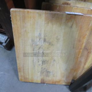 24x18x2 solid wood cutting board with natural grain and visible wear. Sturdy and durable for kitchen use.