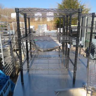 One black Metro shelf unit with four adjustable wire shelves, 24x14x31 inches, outdoors in good condition.
