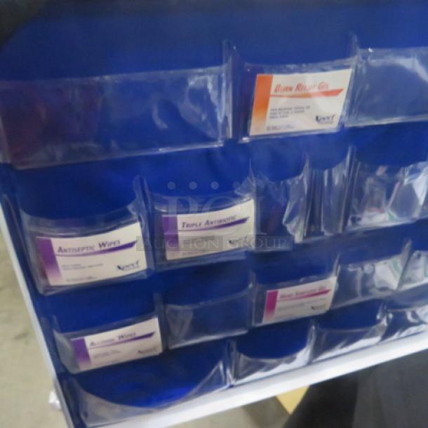 Cintas First Aid Center with labeled compartments for supplies like antiseptic wipes and burn relief gel, in good condition.