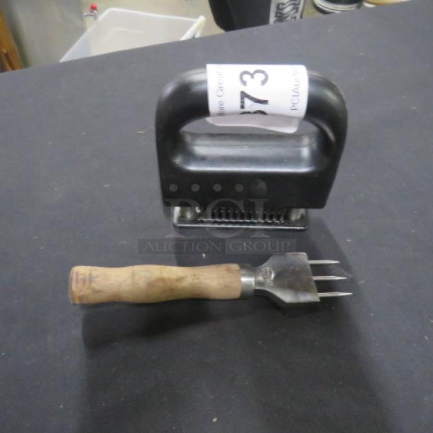 Assorted meat tenderizers; includes black plastic tenderizer and wood-handled metal fork. Item tag "73".