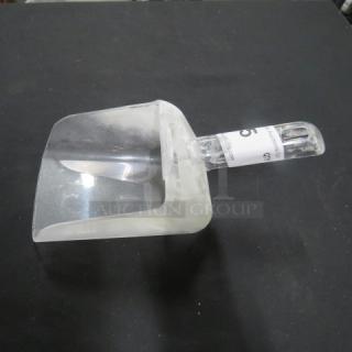 Transparent poly scoop with ergonomic handle, slightly used condition. Auction tag attached.